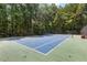 Community tennis court nestled in a wooded area, perfect for a friendly match at 90 Lakeside Dr, Hiram, GA 30141