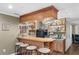Entertainment area with a wet bar, stools and built-in shelves for liquor and glassware at 90 Lakeside Dr, Hiram, GA 30141