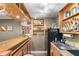 Charming wet bar with wooden cabinets and shelves stocked with glasses and beverages at 90 Lakeside Dr, Hiram, GA 30141