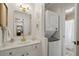 Updated bathroom with gold hardware, vanity, and stacked washer and dryer at 1101 Collier Nw Rd # U6, Atlanta, GA 30318