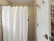 Bathroom featuring shower with hexagon tile surround and glass door to closet at 1101 Collier Nw Rd # U6, Atlanta, GA 30318