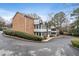 Rear view of the building featuring balconies, sunrooms, and mature trees on the property at 1101 Collier Nw Rd # U6, Atlanta, GA 30318