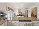 Bright eat-in kitchen featuring granite countertops, white cabinets, and a stainless steel dishwasher at 1101 Collier Nw Rd # U6, Atlanta, GA 30318