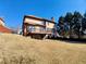 The backyard features a sprawling lawn and a spacious wooden deck at 11365 Donnington Dr, Duluth, GA 30097