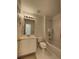 Bright bathroom featuring a shower-tub combo, a toilet, and a vanity with a well lit mirror at 11365 Donnington Dr, Duluth, GA 30097