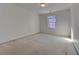 Spacious bedroom with neutral carpet, one window, and a closet door at 11365 Donnington Dr, Duluth, GA 30097