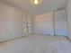 Sunny bedroom featuring French doors, a double closet, and neutral carpet to maximize space at 11365 Donnington Dr, Duluth, GA 30097
