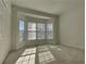 Bedroom featuring carpet, a closet, and three windows at 11365 Donnington Dr, Duluth, GA 30097