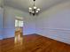 Traditional dining room with hardwood floors, wainscoting and easy access to the kitchen at 11365 Donnington Dr, Duluth, GA 30097
