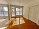 Sun-filled dining room featuring hardwood floors, a classic chandelier, and a view to the exterior at 11365 Donnington Dr, Duluth, GA 30097