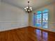 Formal dining room featuring hardwood floors, wainscoting, and a large window with natural light at 11365 Donnington Dr, Duluth, GA 30097