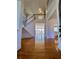 Elegant foyer featuring hardwood floors, high ceilings, a grand staircase, and a chandelier at 11365 Donnington Dr, Duluth, GA 30097