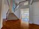 Bright foyer featuring hardwood floors, staircase, and views to living areas at 11365 Donnington Dr, Duluth, GA 30097