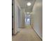 Hallway featuring carpeted flooring and doors at 11365 Donnington Dr, Duluth, GA 30097