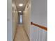 Well-lit hallway with neutral carpeting connects various rooms within the home at 11365 Donnington Dr, Duluth, GA 30097