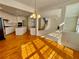 Open floor plan showcasing the kitchen, staircase, and living room with abundant natural light at 11365 Donnington Dr, Duluth, GA 30097