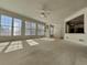 Bright living room featuring large windows offering ample natural light and a ceiling fan at 11365 Donnington Dr, Duluth, GA 30097