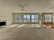 Expansive living room with large windows, neutral carpet, and fireplace at 11365 Donnington Dr, Duluth, GA 30097
