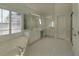 The main bathroom has a large vanity, soaking tub, and tile floors at 11365 Donnington Dr, Duluth, GA 30097