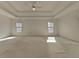 Spacious main bedroom with a tray ceiling, carpet, and lots of natural light at 11365 Donnington Dr, Duluth, GA 30097