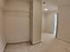 Bright walk-in closet with wall to wall carpeting and adjacent bathroom for added convenience at 11365 Donnington Dr, Duluth, GA 30097