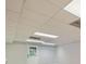 Basement with tile ceiling, bright lighting, and a back door at 140 Grosvenor Pl, Atlanta, GA 30328