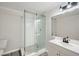 Updated bathroom featuring a glass shower, mosaic floor, white herringbone tile, and modern vanity at 140 Grosvenor Pl, Atlanta, GA 30328