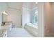 Bright bathroom features a garden tub, a separate shower and stylish fixtures at 140 Grosvenor Pl, Atlanta, GA 30328