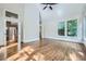 Bright bedroom features hardwood floors, large windows, and a ceiling fan at 140 Grosvenor Pl, Atlanta, GA 30328