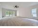 Spacious bedroom with a ceiling fan, neutral carpet and access to a private balcony at 140 Grosvenor Pl, Atlanta, GA 30328