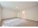 Large open room with a new carpet, white trim and easy access to a bathroom at 140 Grosvenor Pl, Atlanta, GA 30328