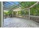 Inviting deck area with pergola, charming railing detail, and wooded views at 140 Grosvenor Pl, Atlanta, GA 30328