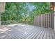 Spacious wooden deck surrounded by a privacy screen and lush greenery, offering a serene outdoor space at 140 Grosvenor Pl, Atlanta, GA 30328
