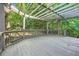 Open air wooden deck with a wood pergola covering, surrounded by leafy green trees at 140 Grosvenor Pl, Atlanta, GA 30328
