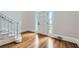 Bright foyer featuring hardwood floors, a staircase, and a white front door with sidelights at 140 Grosvenor Pl, Atlanta, GA 30328