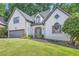 Beautiful home featuring a well-manicured lawn and a symmetrical design with elegant architectural details at 140 Grosvenor Pl, Atlanta, GA 30328