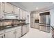 Contemporary kitchen featuring stainless steel appliances and marble tile flooring at 140 Grosvenor Pl, Atlanta, GA 30328