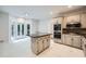 Modern kitchen with a center island, double ovens, and access to the outdoor deck at 140 Grosvenor Pl, Atlanta, GA 30328