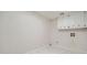 The laundry room has white cabinets, white tile flooring and light gray walls at 140 Grosvenor Pl, Atlanta, GA 30328