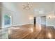 Expansive living room with hardwood floors, a fireplace, and large windows with treetop views at 140 Grosvenor Pl, Atlanta, GA 30328