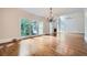 Spacious living room with hardwood flooring, fireplace and large windows overlooking the backyard at 140 Grosvenor Pl, Atlanta, GA 30328