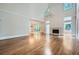 Spacious living room featuring hardwood floors, a fireplace, and soaring ceilings with a chandelier at 140 Grosvenor Pl, Atlanta, GA 30328
