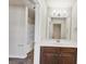 Well-lit bathroom with a vanity, large mirror, and bath-shower combo at 3777 Shady Maple Dr, Lithonia, GA 30038