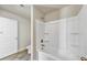 A well-lit bathroom features a white bathtub with shower and a tiled floor at 3777 Shady Maple Dr, Lithonia, GA 30038