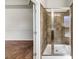 Bathroom with a large glass enclosed shower, neutral tile, and a view to another room at 3777 Shady Maple Dr, Lithonia, GA 30038