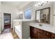 Bright bathroom featuring a soaking tub, dark wood vanity, and tiled flooring at 3777 Shady Maple Dr, Lithonia, GA 30038