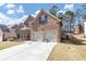 Beautiful brick house features a two-car garage, complemented by a manicured front yard and driveway at 3777 Shady Maple Dr, Lithonia, GA 30038
