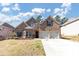 Charming two-story brick home boasts a two-car garage, mature landscaping, and a well-maintained lawn at 3777 Shady Maple Dr, Lithonia, GA 30038