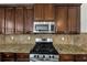 Close up of an updated kitchen with stainless appliances, granite countertops, and custom cabinetry at 3777 Shady Maple Dr, Lithonia, GA 30038