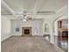 Bright living room with a ceiling fan, gas fireplace, hardwood floors, open to the kitchen with granite countertops at 3777 Shady Maple Dr, Lithonia, GA 30038